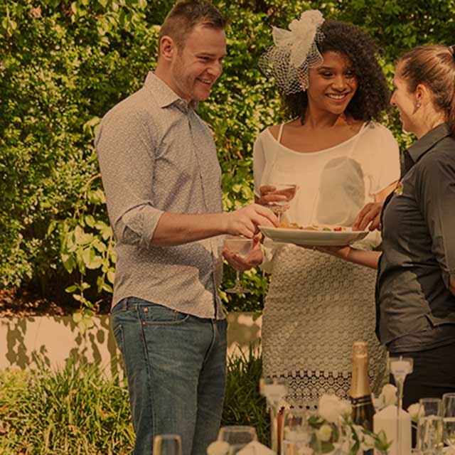 Wedding guests at a Brazilian BBQ catered event