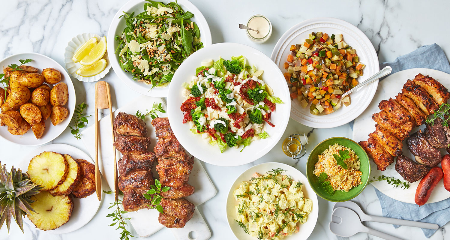 Freshly made Brazilian BBQ dishes and salads laid out on a table